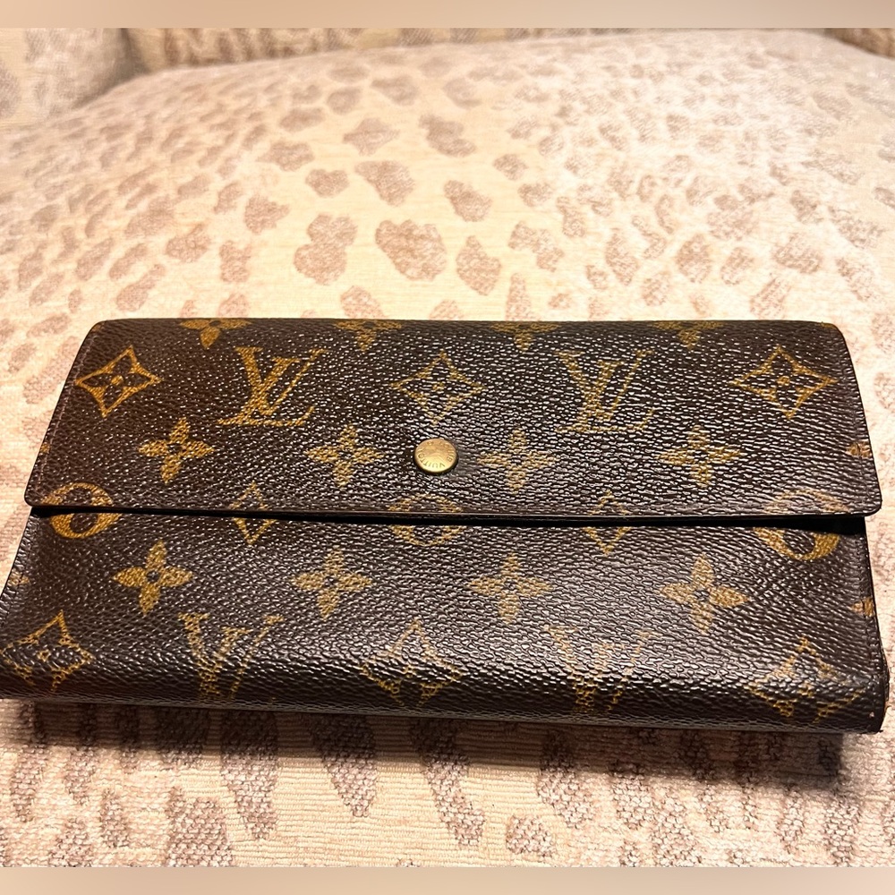 Louis Vuitton International Wallet in monogram logo.